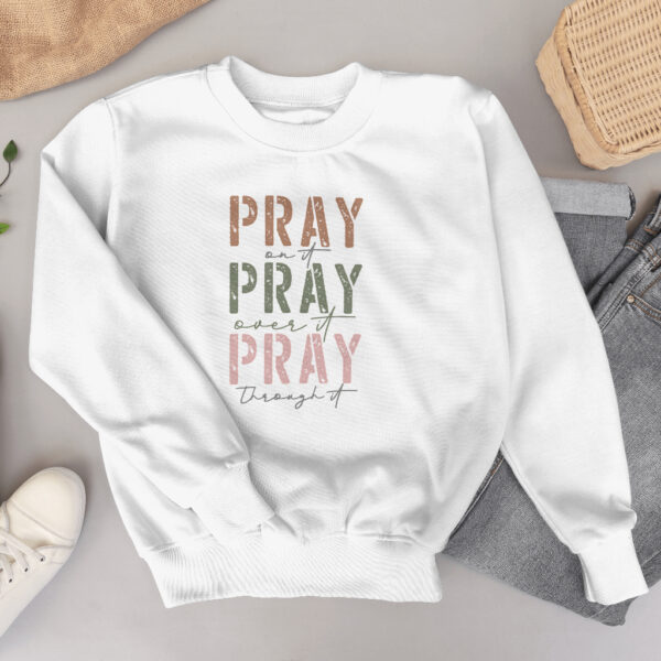 Pray on It Gildan 18000 crewneck sweatshirt featuring the message 'Pray on It, Pray Over It, Pray Through It.' Made from a 50/50 cotton-poly blend, providing warmth and comfort. Available in multiple colors and sizes.